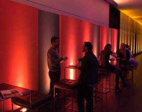 Up-lit alternating Orange and Grey Temporary wall of AV-Drop Modular backdrop for social event décor.
